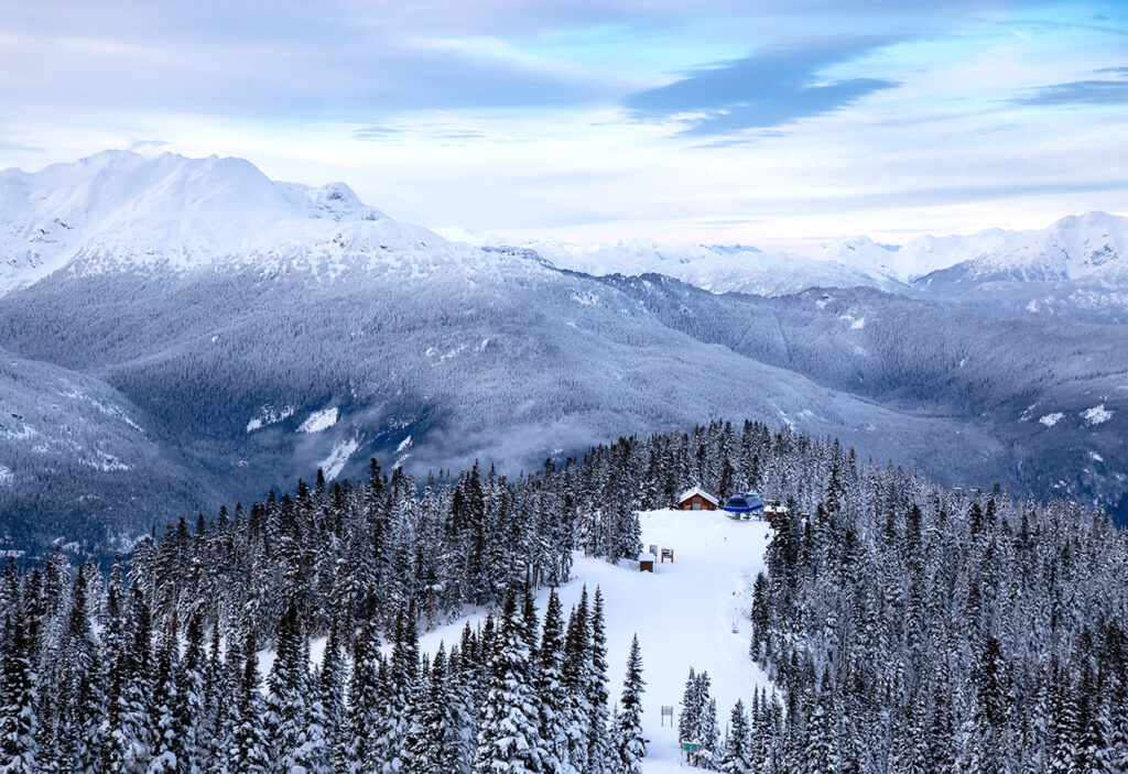 Whistler, British Columbia, Canada. Beautiful View of the Canadian Snow Covered Mountain Landscape during a cloudy and colorful winter sunset.